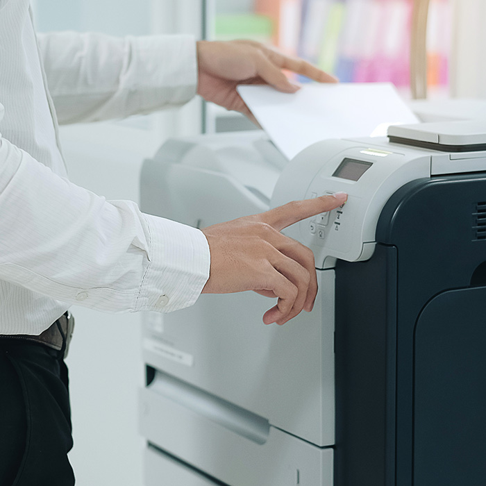 Business person using multi-function copier.