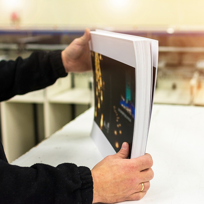 Business person sorting color copies.