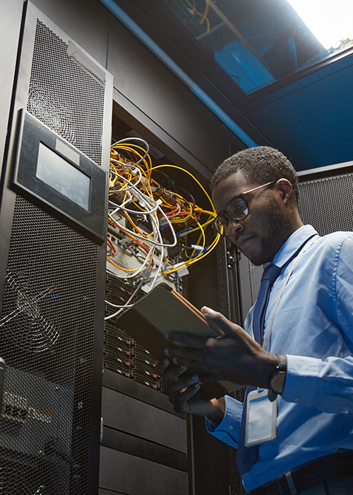 IT technician in server room.